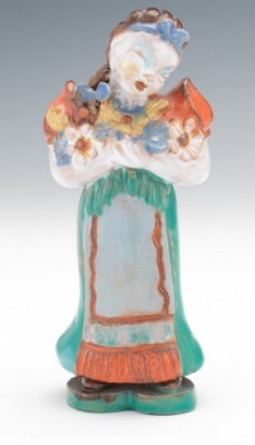 A Glazed Ceramic Figurine Of A Girl Holding An Armful Of Flowers by Maria RAHMER